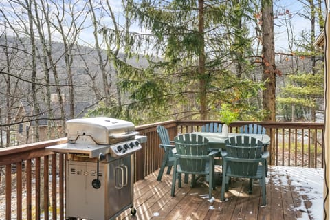 Private patio with an outdoor dining area, BBQ grill, and mountain views.