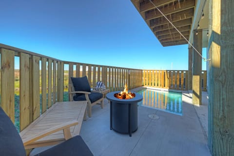 Private patio with pool and firepit—unwind with pond views and coastal breezes from your own outdoor retreat.