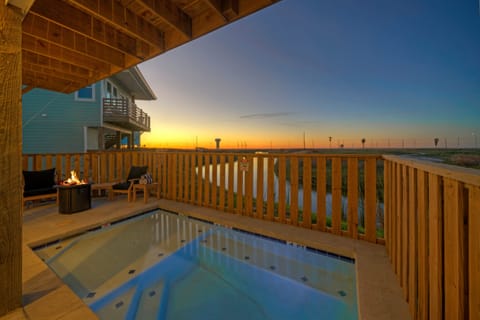 Golden hour from your private pool—unwind with panoramic sunset views over the pond and coastal sky.