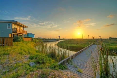Golden hour along the boardwalk—peaceful marsh views and coastal sunsets just steps from your stay.