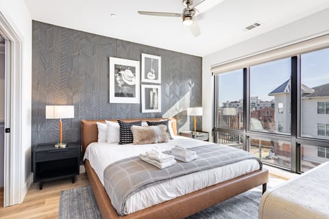 The primary bedroom features a king bed, a walk-in closet, and an ensuite bathroom.