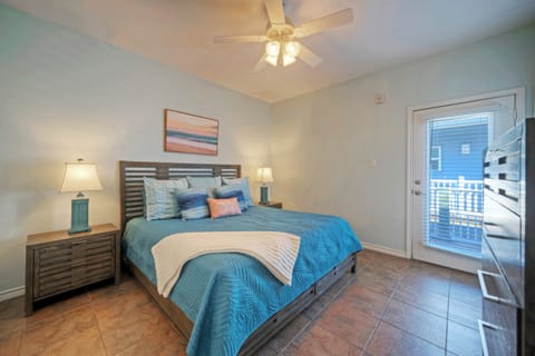 The primary bedroom features a king bed, access to the balcony, TV, and an ensuite bathroom. (Costa Bahia 203)