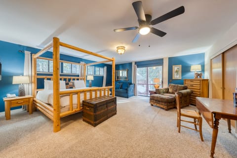 Primary bedroom features a king bed, balcony, ensuite bathroom, and a desk.