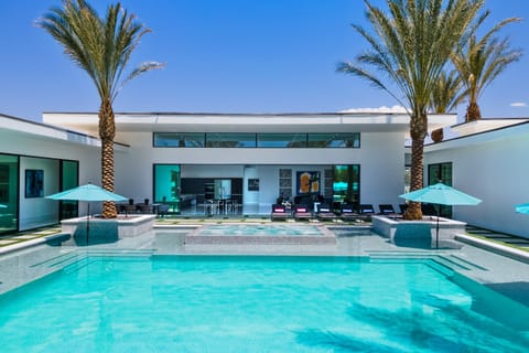 Massive custom pool with LED waterfalls, fire bowls & tanning shelves.