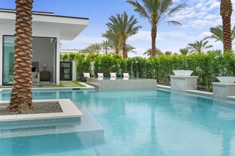Sparkling custom pool with LED waterfalls & tanning shelves.