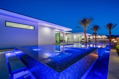 Aerial view of the modern luxury community with sleek homes, private pools, and scenic mountain backdrops.