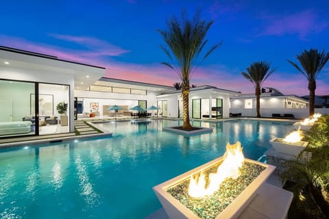 Aerial view of the modern luxury community with sleek homes, private pools, and scenic mountain backdrops.