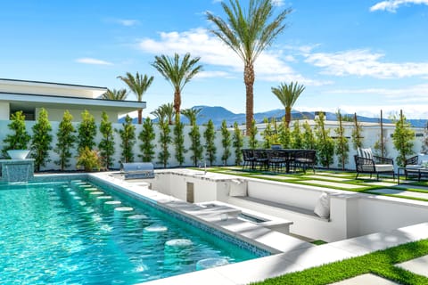 Sparkling custom pool with LED waterfalls & tanning shelves.