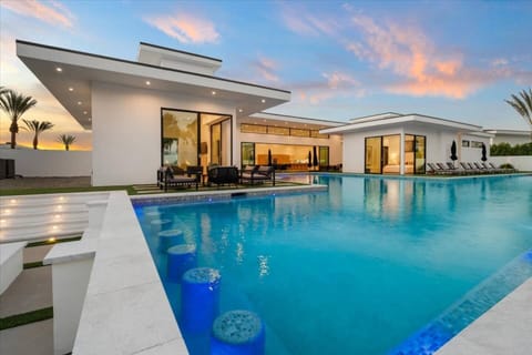 Aerial view of the modern luxury community with sleek homes, private pools, and scenic mountain backdrops.