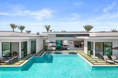 Aerial view of the modern luxury community with sleek homes, private pools, and scenic mountain backdrops.