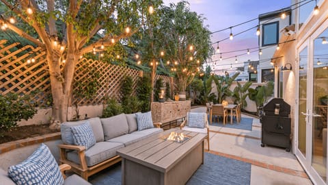 Relax under twinkling lights in this cozy patio setting.