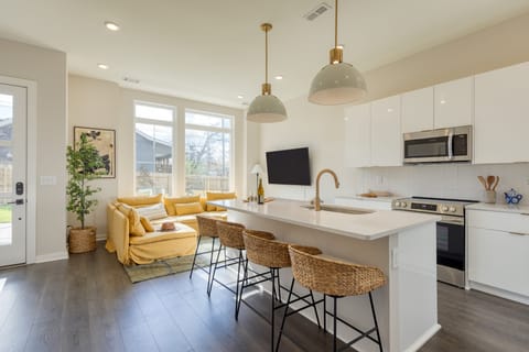 Kitchen features an island with barstool seating. (98 Degrees)