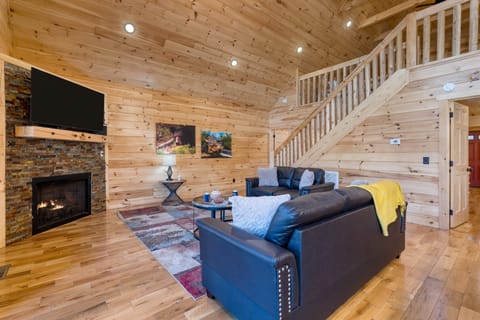 Cozy living area with vaulted ceilings and a fireplace.