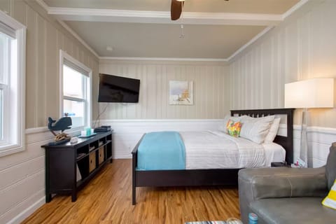 Cozy studio space with a plush bed and calming décor for a restful stay.