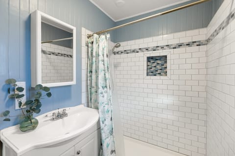 Clean and bright full bathroom with a relaxing tub — perfect for soaking after a long day.