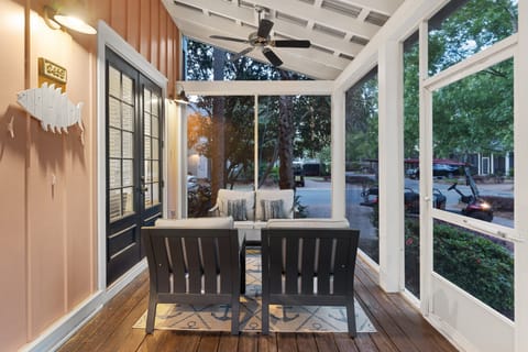 Relax and enjoy the breeze with comfortable seating on the front porch.