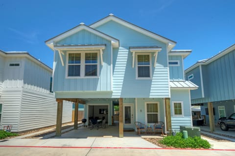 Charming coastal-style home with elevated design and bright blue exterior.