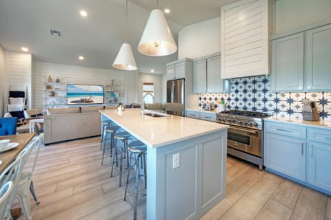 Chef-inspired kitchen with a large island and stainless steel appliances.