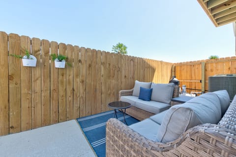 Intimate outdoor seating area tucked behind a privacy fence.
