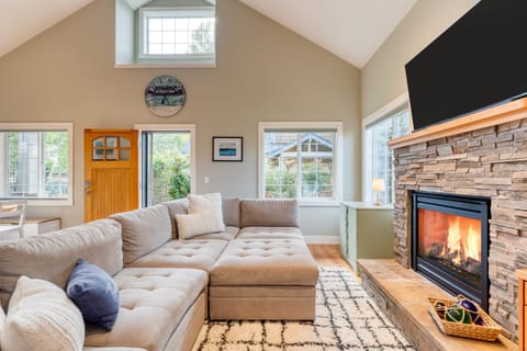 Sectional couch with TV and fireplace in the living room for cozy gatherings.