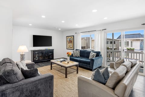 Bright interior with ample seating and a large TV for relaxing movie nights.