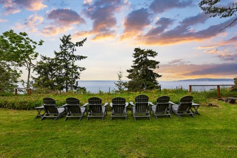 Peaceful outdoor setting with Adirondack chairs.