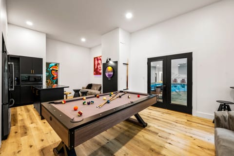 Lounge area with a kitchenette, bistro seating, and a pool table.