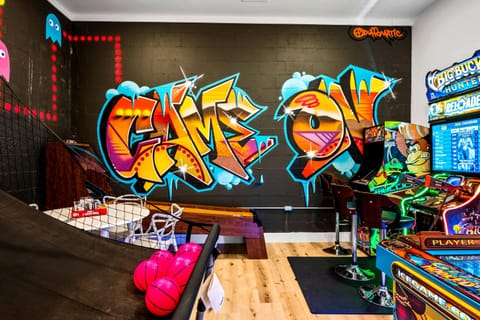 Colorful graffiti-themed arcade room for endless fun.