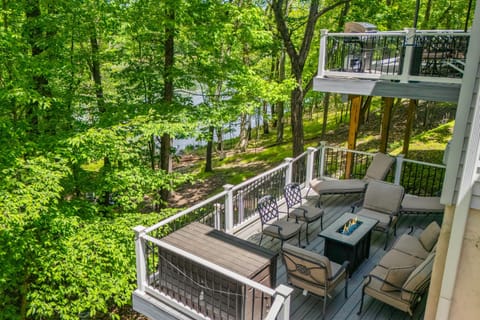 Balcony with cozy seating and forest views.