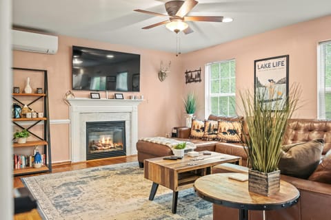 Inviting living room with fireplace, mounted TV, and stylish decor.