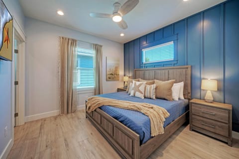 Bedroom 2 with king bed, TV, closet, and private ensuite bathroom access.