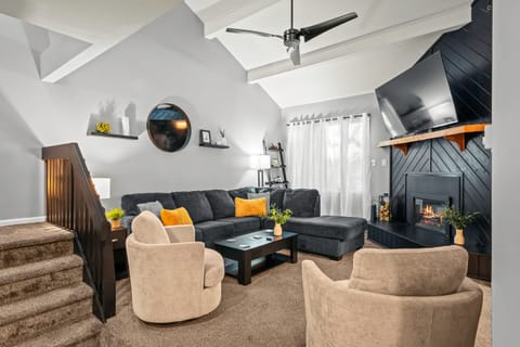 Living room with comfortable seating, a cozy fireplace, and a TV for relaxing nights in.