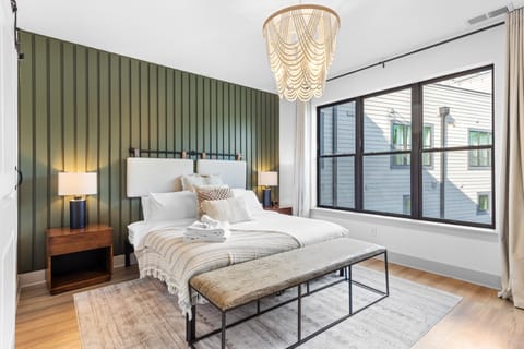 The primary bedroom features a queen bed, TV and an ensuite bathroom.