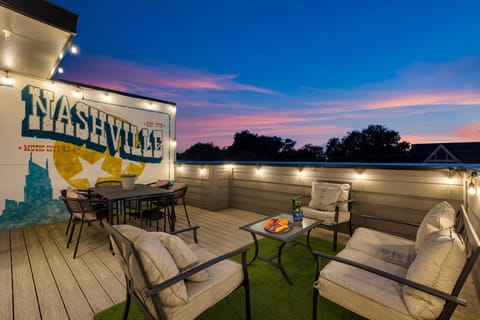 Rooftop terrace with a dining table and cozy lounge seating—perfect for starlit evenings.