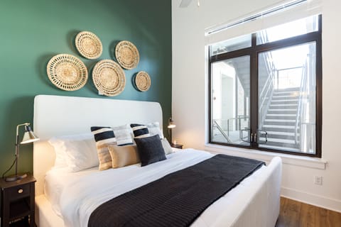 The primary bedroom features a king bed and an ensuite bathroom. (The Heights 401)