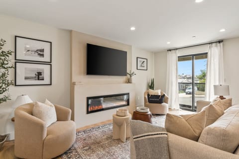 Living room with comfortable seating and a TV for relaxing nights in. (Point View Luxe)