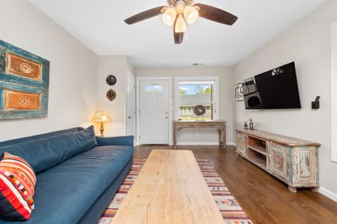 Living room features a sofa and TV. (Little Sycamore)