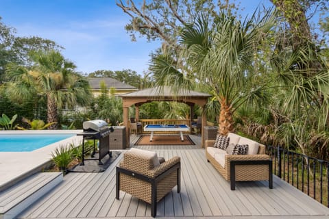Covered porch with cozy outdoor seating.