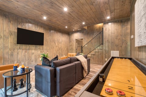 Spacious rec room with wood ceilings and plush seating.