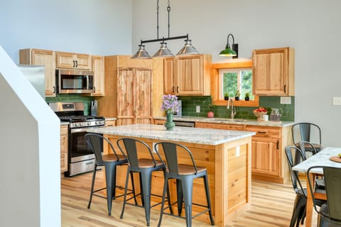 Fully equipped kitchen with barstool seating.