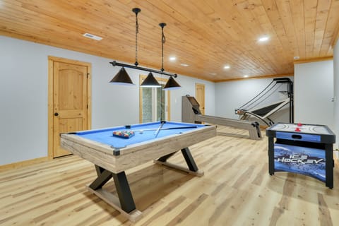 Game room featuring a pool table, basketball hoop, and air hockey table.