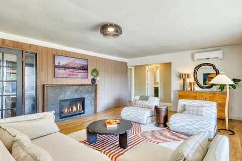 Living room with comfortable seating, TV, and a cozy fireplace.