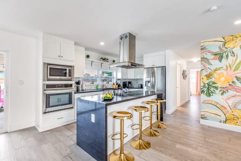 Sleek kitchen with island and barstool seating.