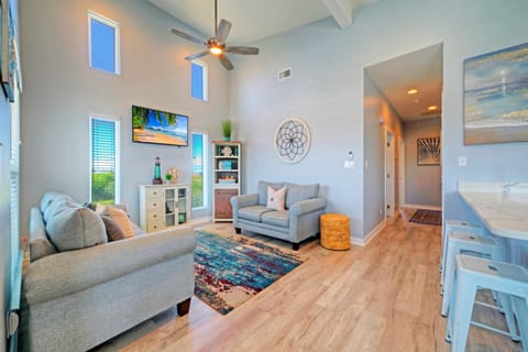 Spacious living area with sofa and coastal decor.