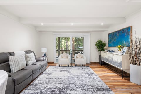 Living room with cozy seating, charming decor, and seamless access to the balcony.