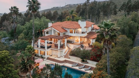Welcome to The Ranch! A breathtaking multi-story Mediterranean estate nestled in a lush hillside enclave with a private resort-style pool.