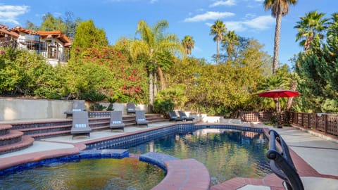 Escape the everyday with a private pool and jacuzzi, surrounded by lush landscaping.