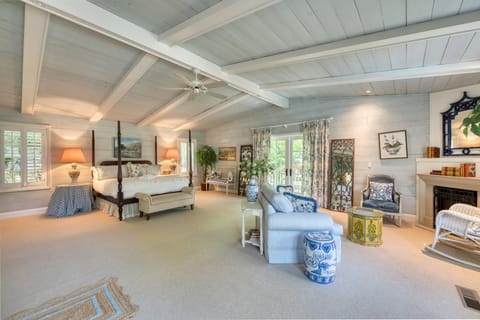 Primary bedroom suite with four-poster bed and fireplace.
