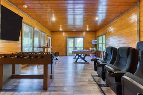 The perfect spot for fun and games. This entertainment room features a foosball table, pool table, and theater seating for movie nights.