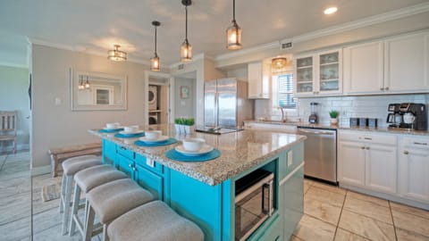 Sleek, modern kitchen with center island table and barstool seating.